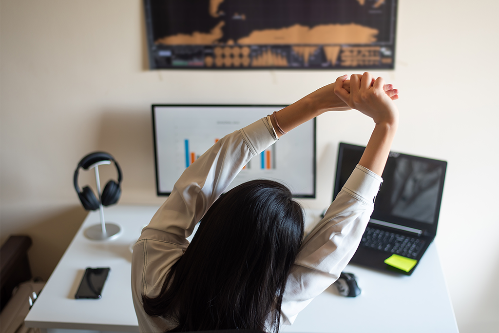 person stretching at desk