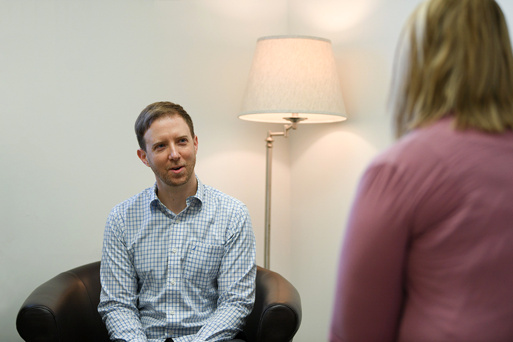 Young man on chair in behavioral therapy session