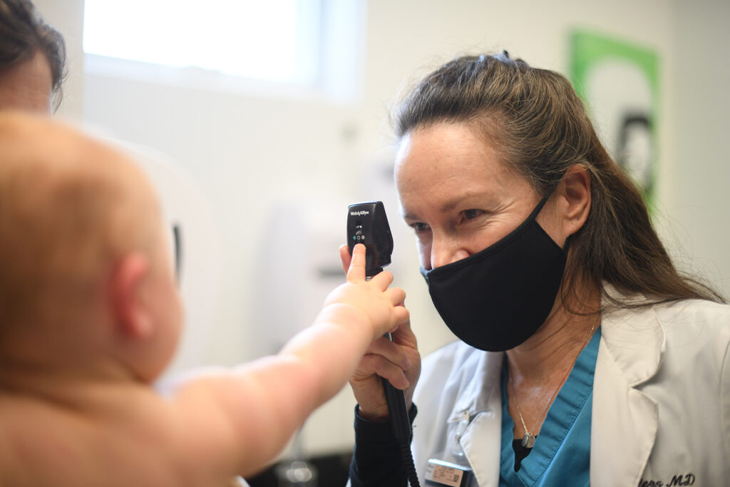 Family medicine doctor treats baby